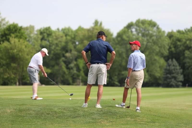 a group of men playing golf