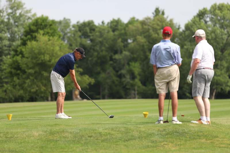 a group of men playing golf