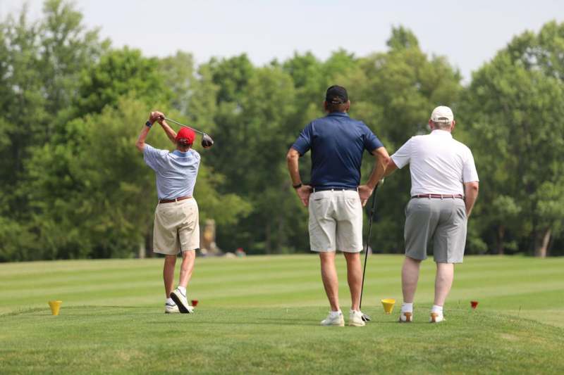 a group of men playing golf
