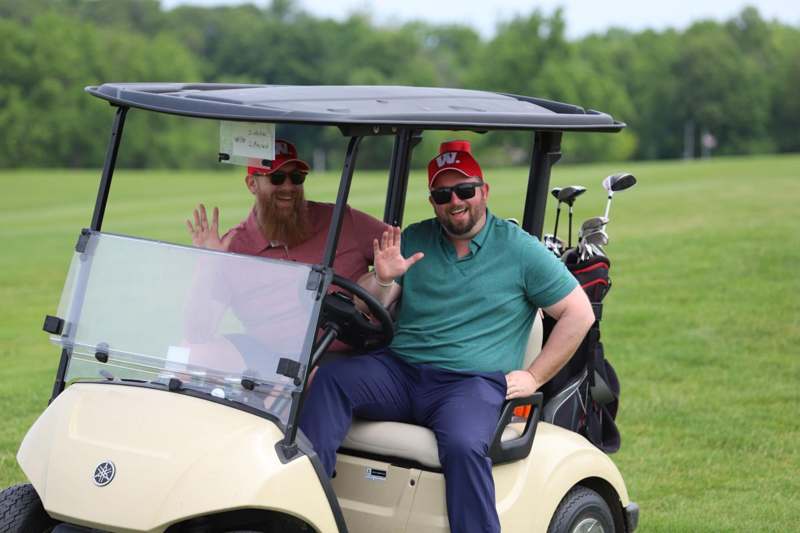two men in a golf cart