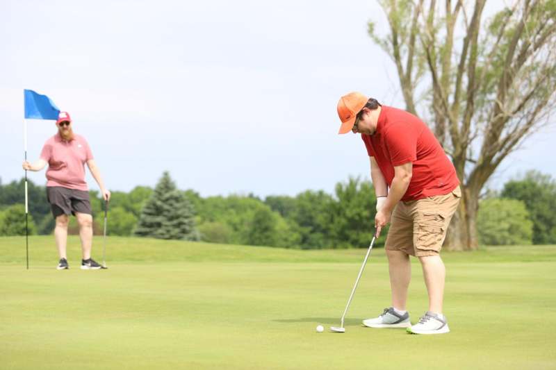 a man and woman playing golf