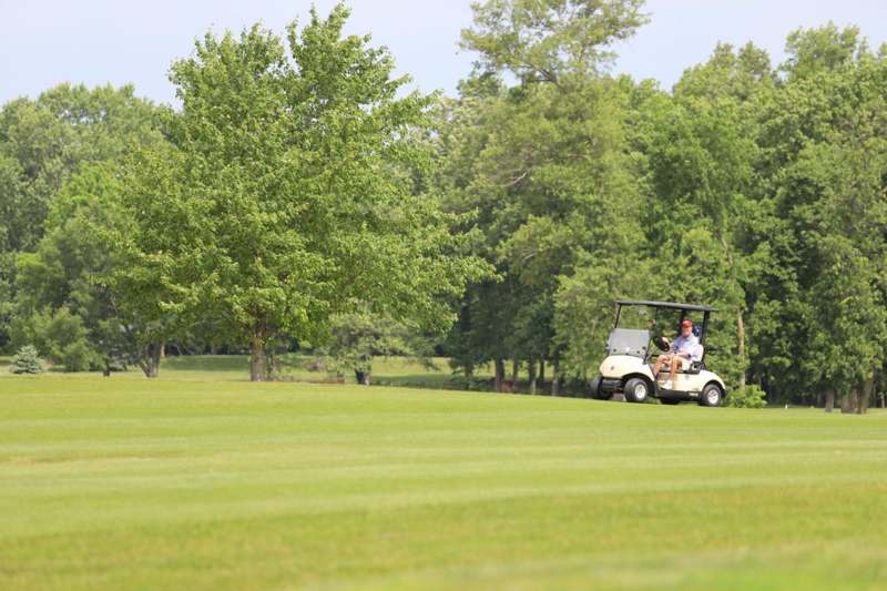 a man driving a golf cart
