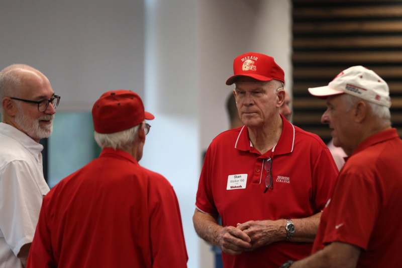 Football Alumni Breakfast - a group of men wearing red shirts and hats