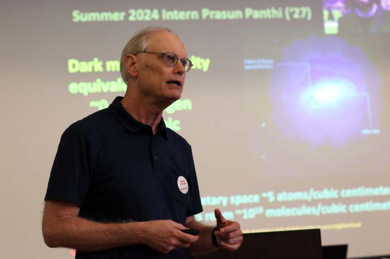 2026 Ides of August - a man standing in front of a projection screen