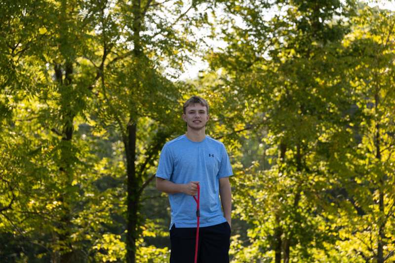 a man standing in front of trees