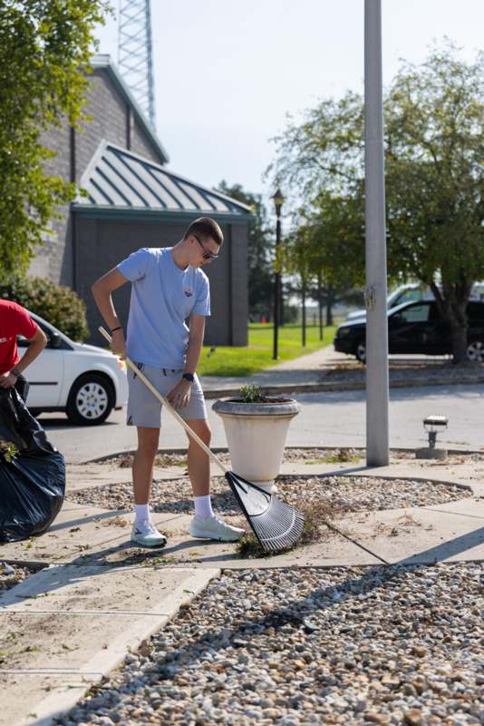a man holding a rake