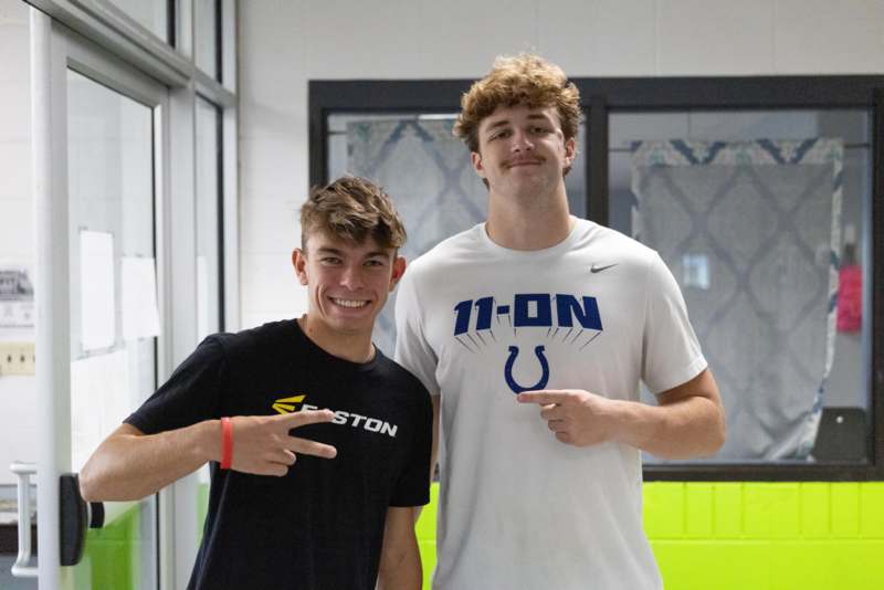 two men standing in a room