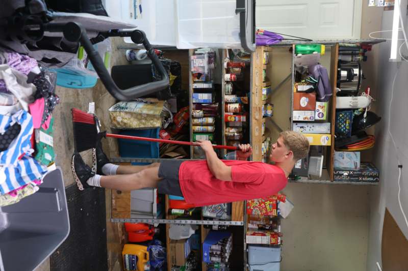 a man sweeping a floor in a garage