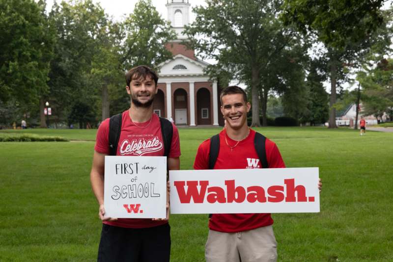 two men holding a sign