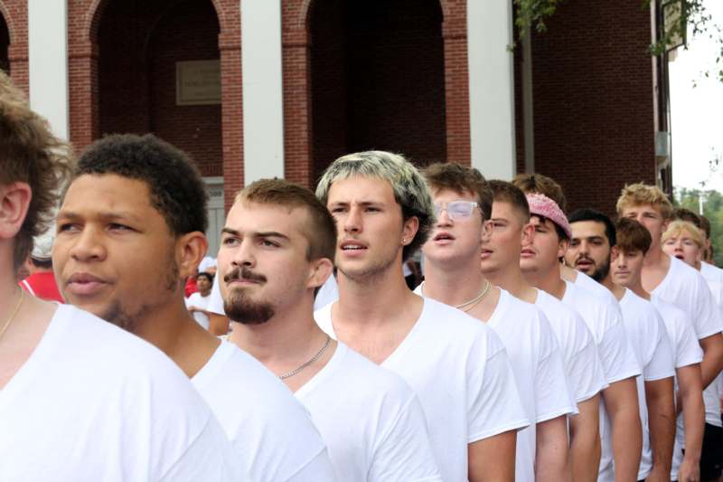 a group of men in white shirts
