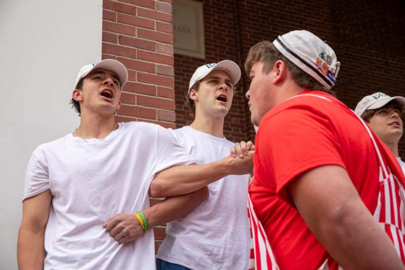 a group of men in white caps