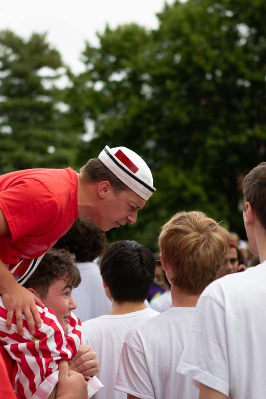 a man standing on another man's shoulders
