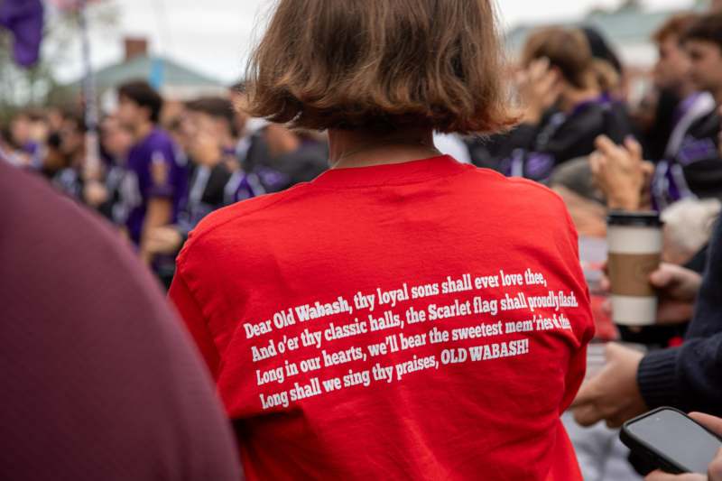 a person wearing a red shirt with white text on it