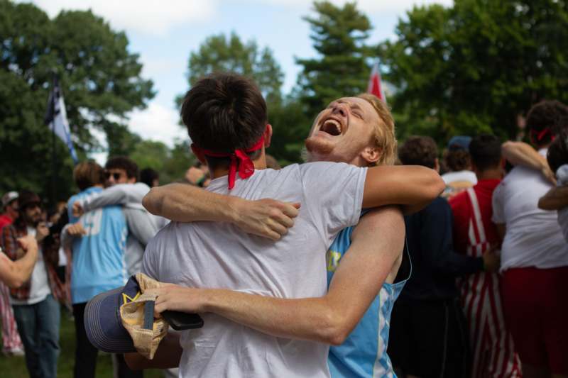 two men hugging each other