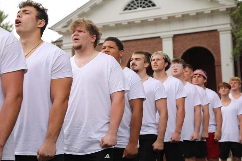 a group of men in white shirts