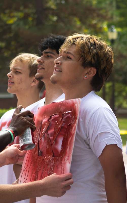 a group of people holding a red sign