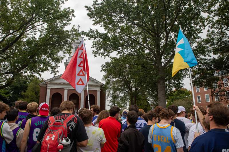 a group of people standing outside with flags
