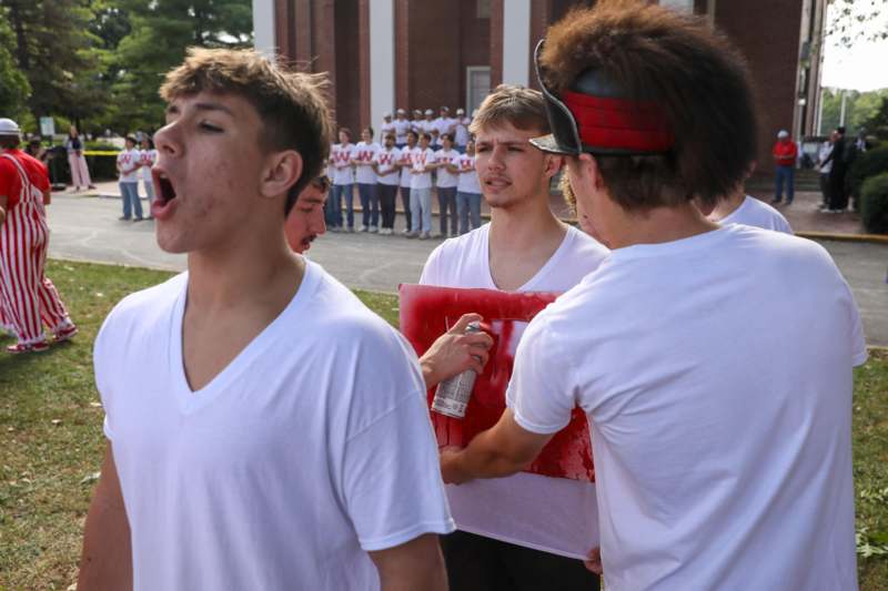 a group of people in white shirts
