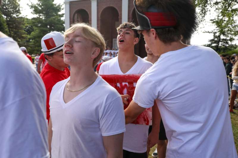 a group of people in white shirts