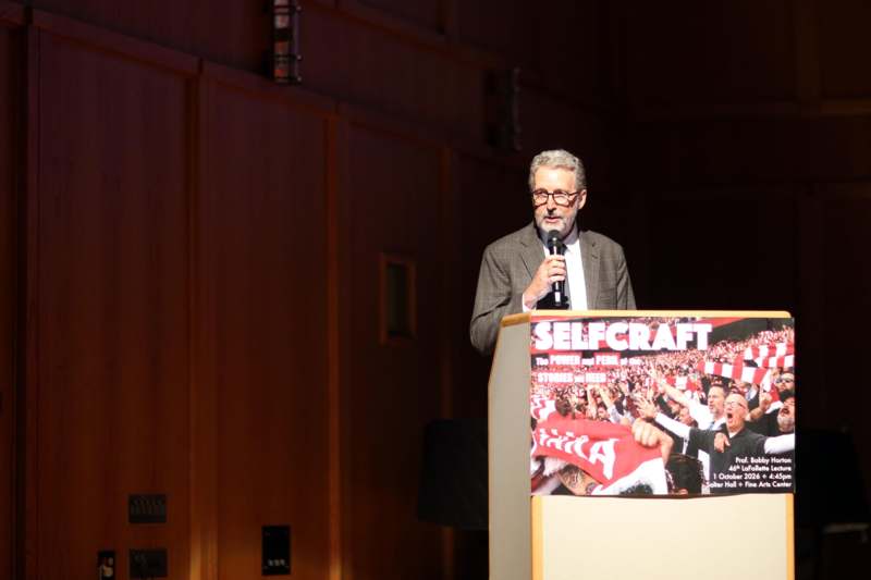 a man standing at a podium speaking into a microphone