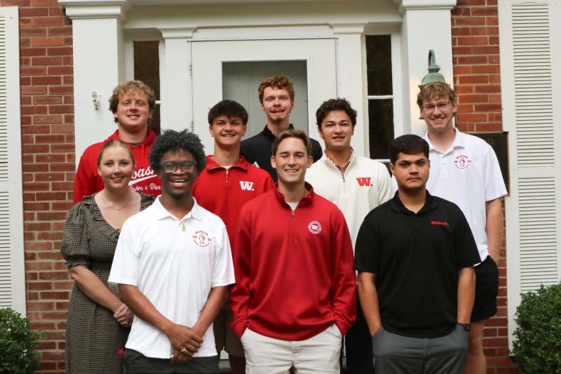 Meet Your Peer Health Educators - a group of people standing in front of a building