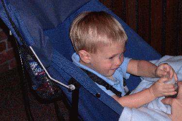a young boy sitting in a stroller