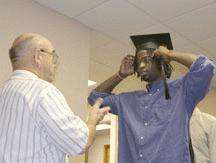 a man fixing a graduation cap