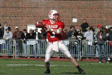 a football player in a red uniform throwing a football