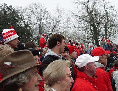 a crowd of people in red and white hats
