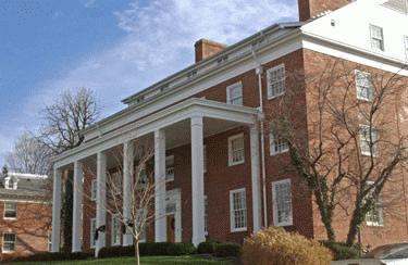 a large brick building with white pillars