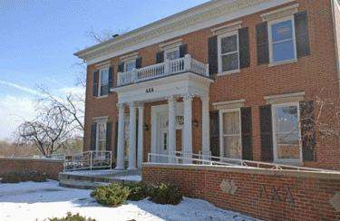 a brick building with a white porch