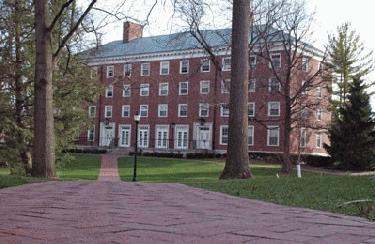 a brick walkway leading to a large building