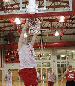 a man dunking a basketball hoop